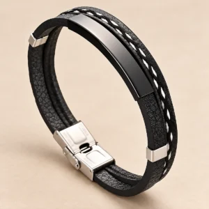 Pulsera negra con placa lisa y costura blanca