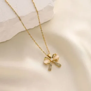 Collar dorado con moño nacarado